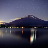 山中湖から望む夜の富士山（登山者の明かり）の写真 「夏の終わりの灯火」
