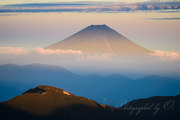 南アルプス赤石岳より夕日に染まる富士山の写真 「光の矢」